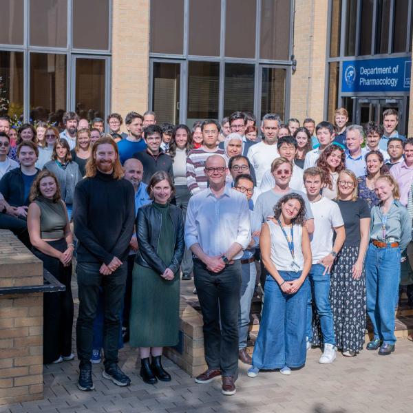 a group photo of people in front of a building