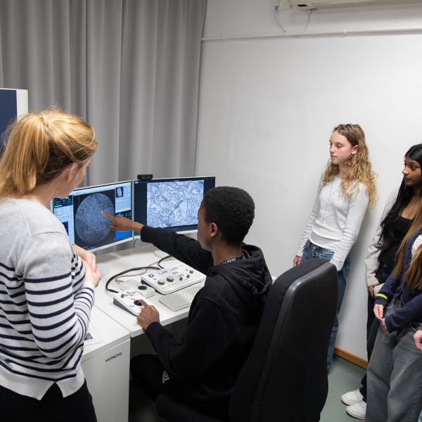 a research and students with a transmission electron microscope