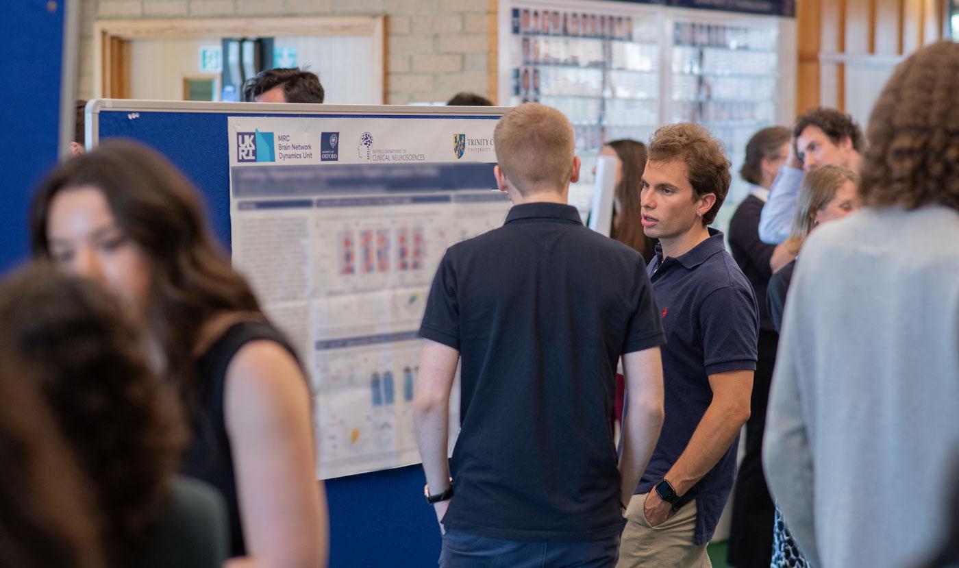 A photo of Unit researchers talking at Summer Science Day 2024.