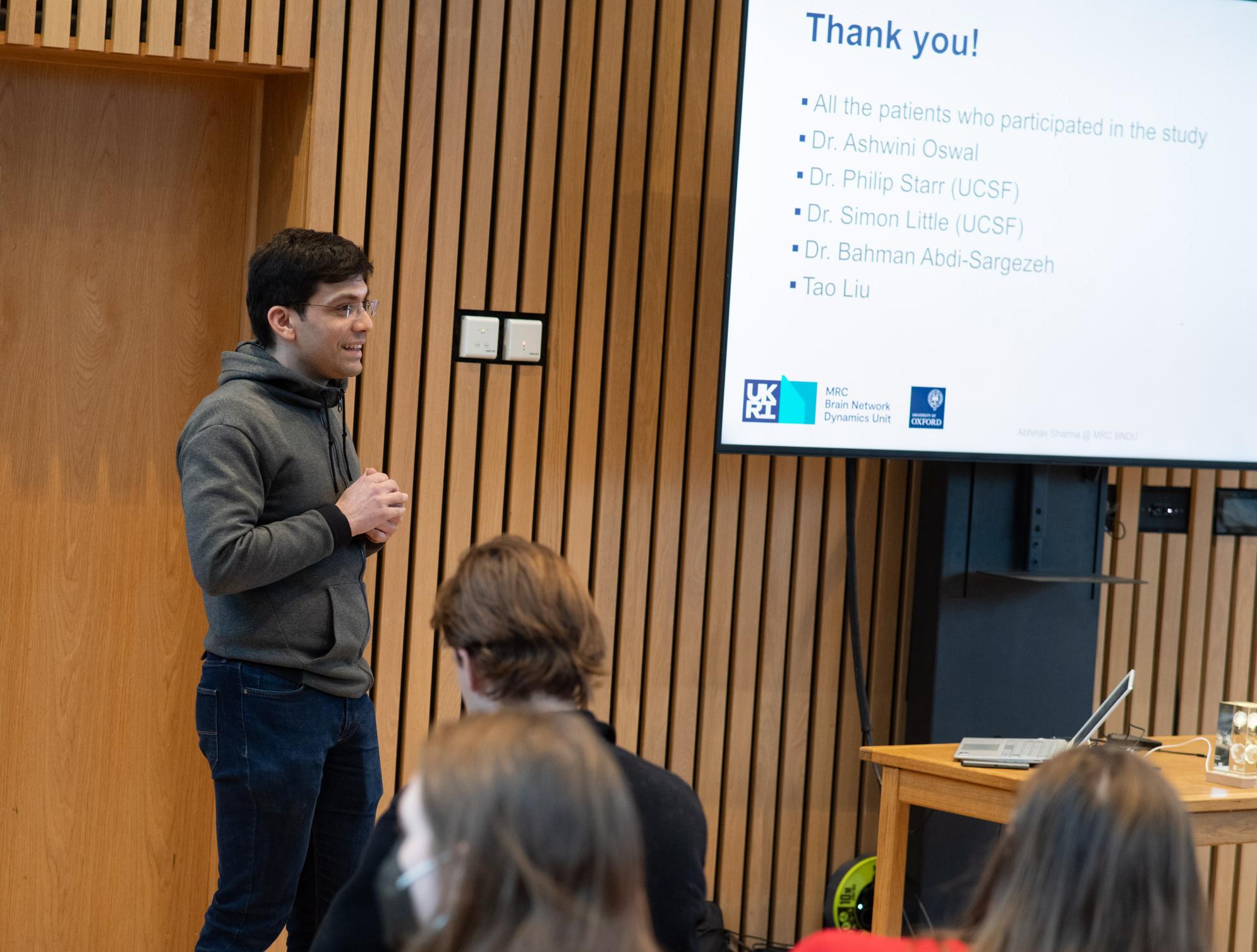 A photo of Abhinav Sharma presenting his research to Unit colleagues.