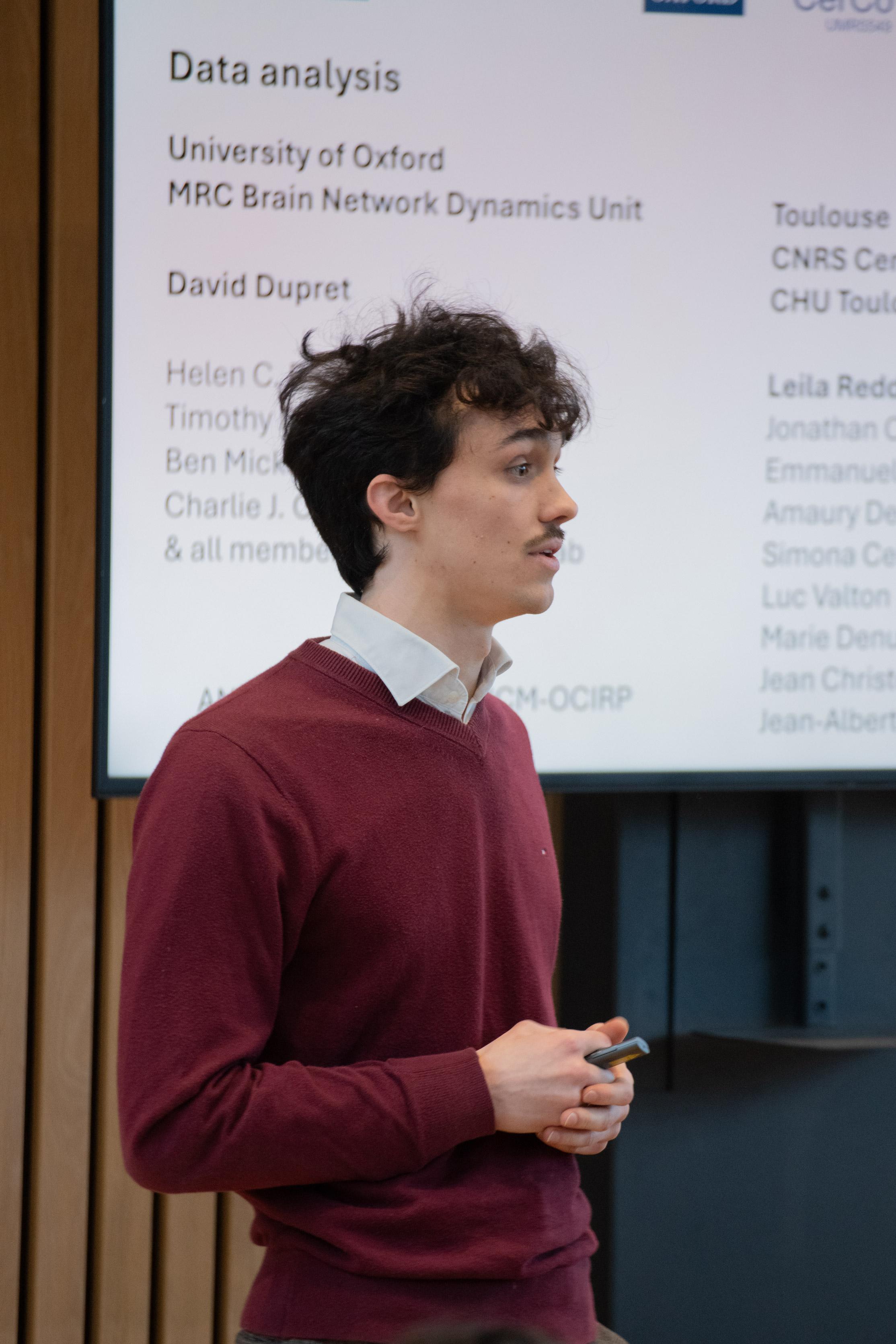A photo of Adrien Causse presenting his research to Unit colleagues