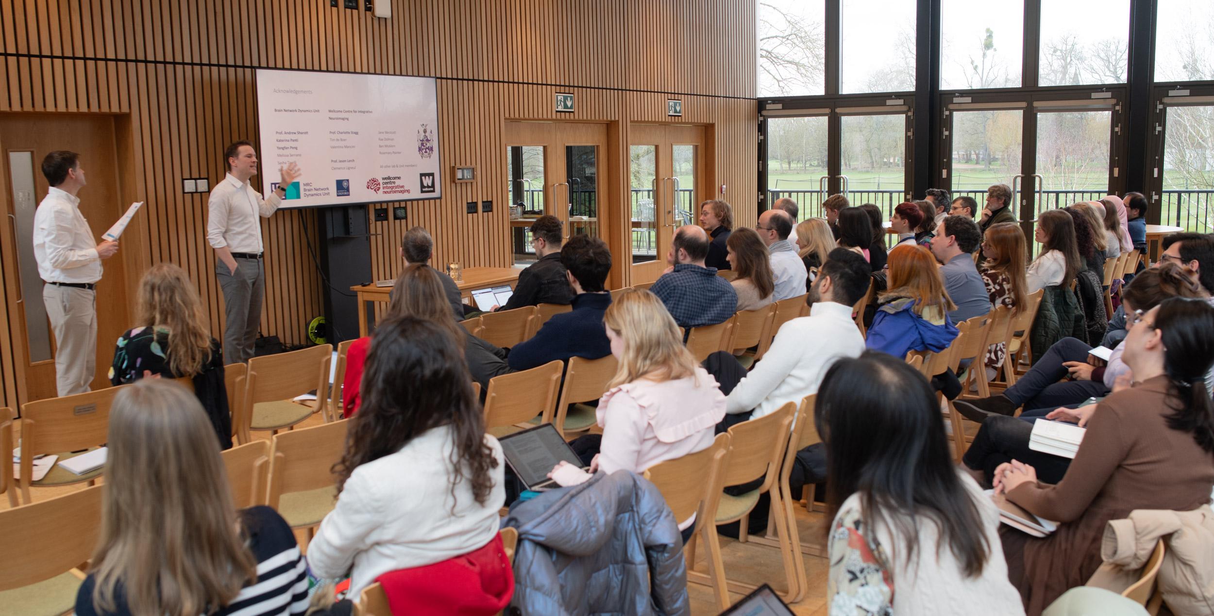 A photo of Jeffrey Stedehouder presenting his research to Unit colleagues.