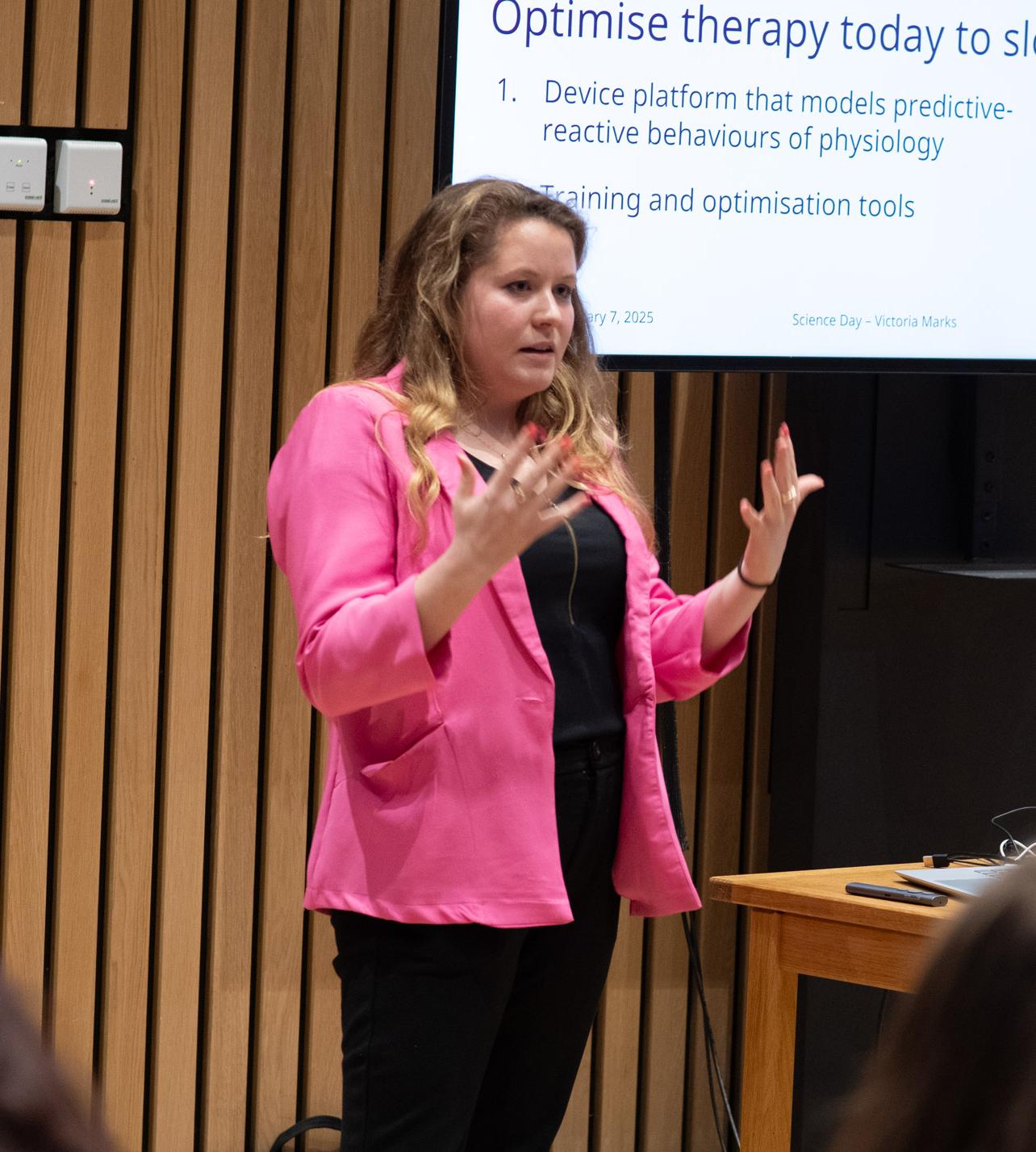 A photo of Tory Marks presenting her research to Unit colleagues.