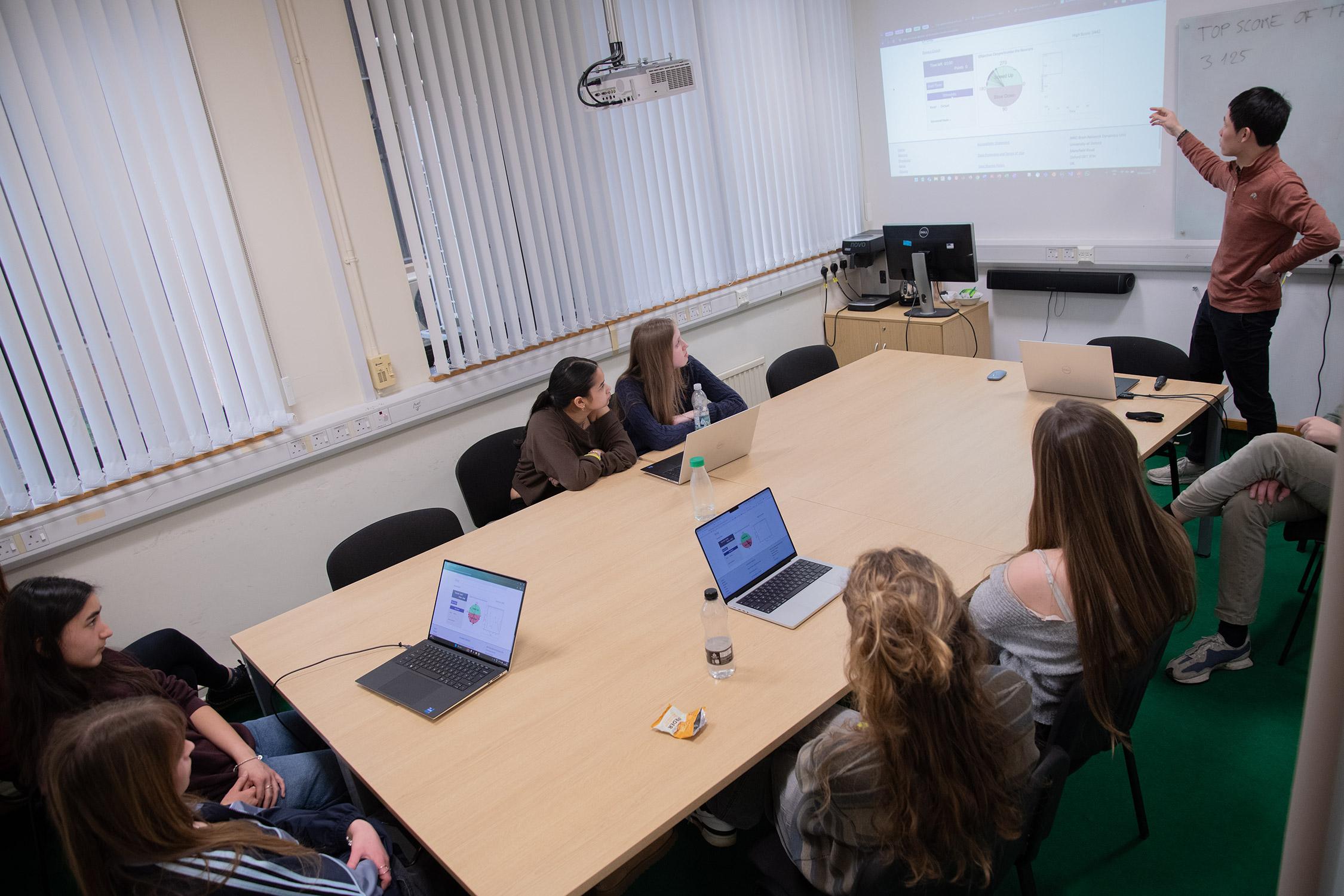 Photo of Yuhao Wang, together with school pupils visiting the BNDU.