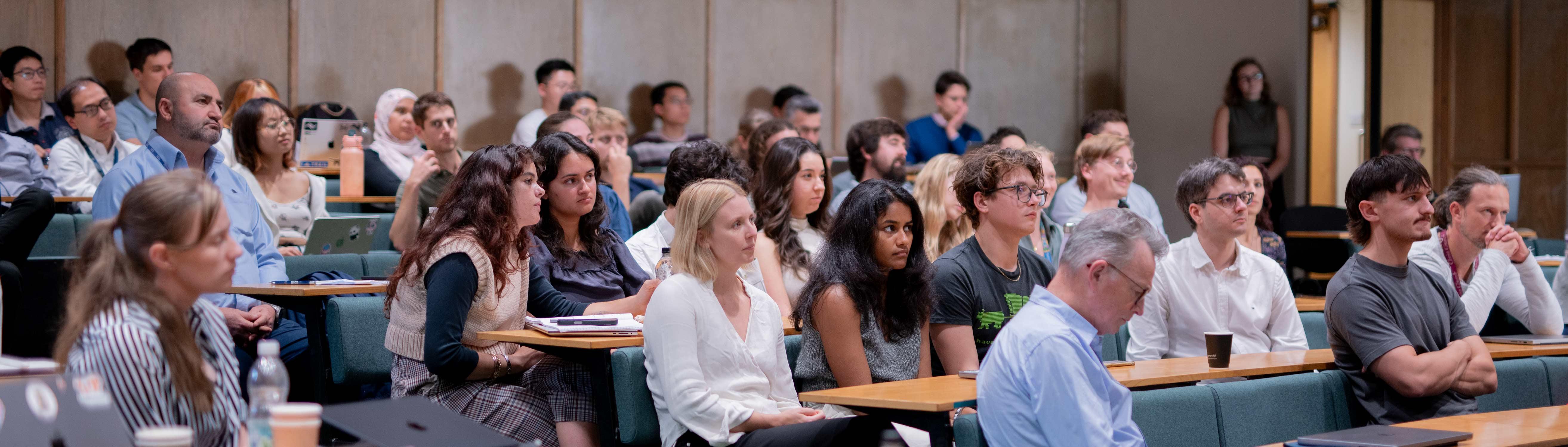 people sat down in the audience, looking engaged