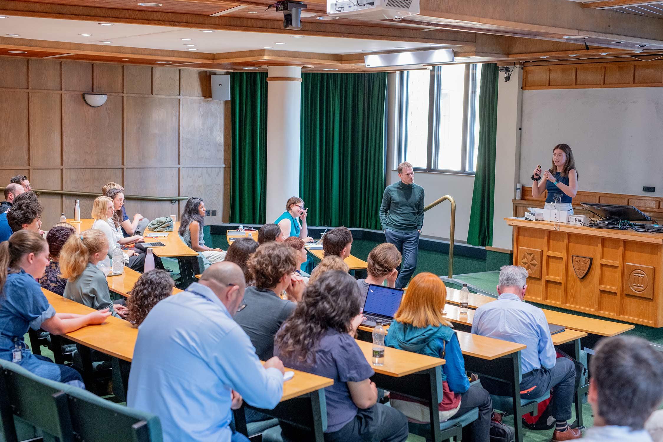a scientist addresses an audience in a lecture theatre