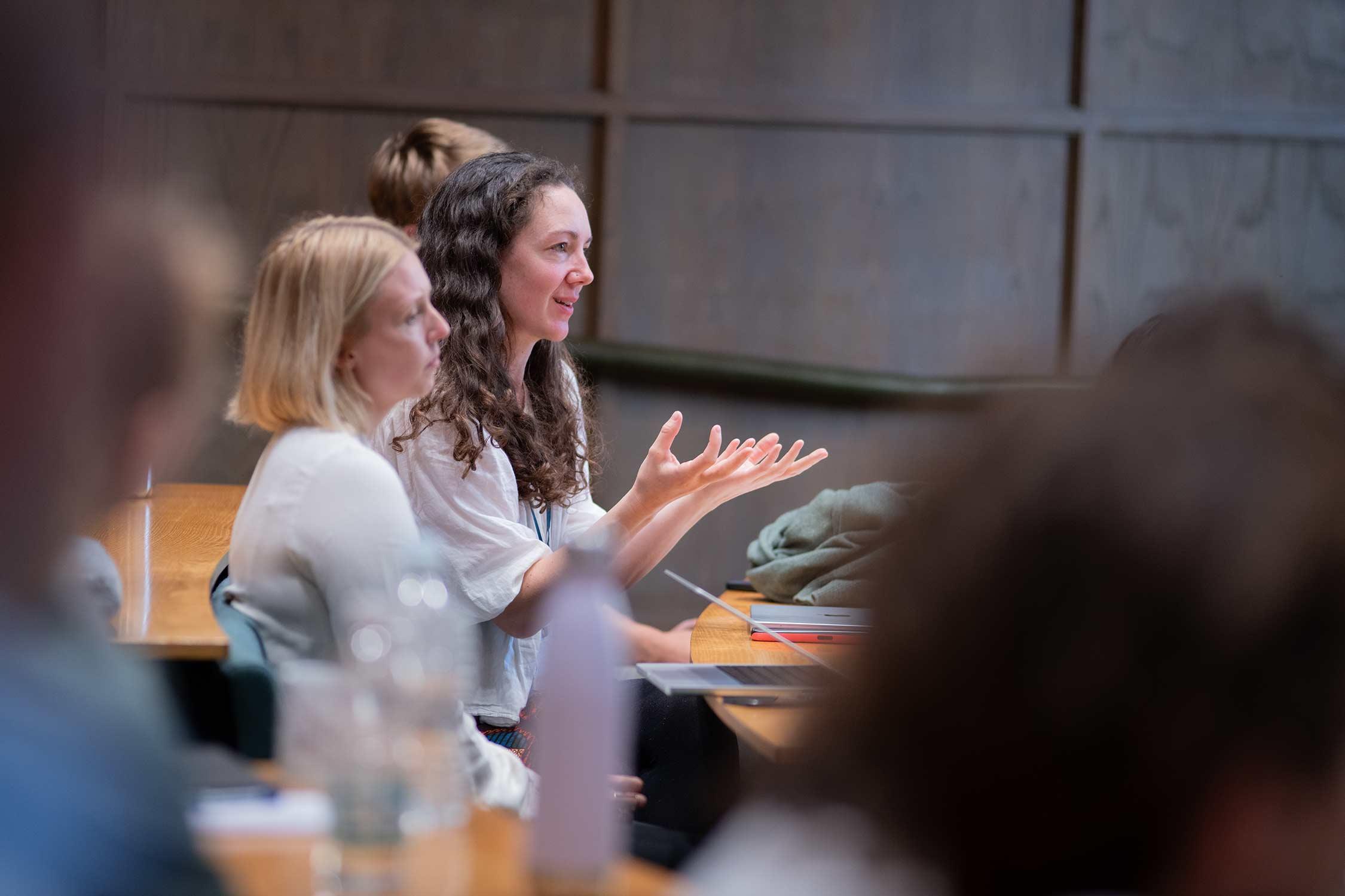 a person asks a question, using their hands for emphasis