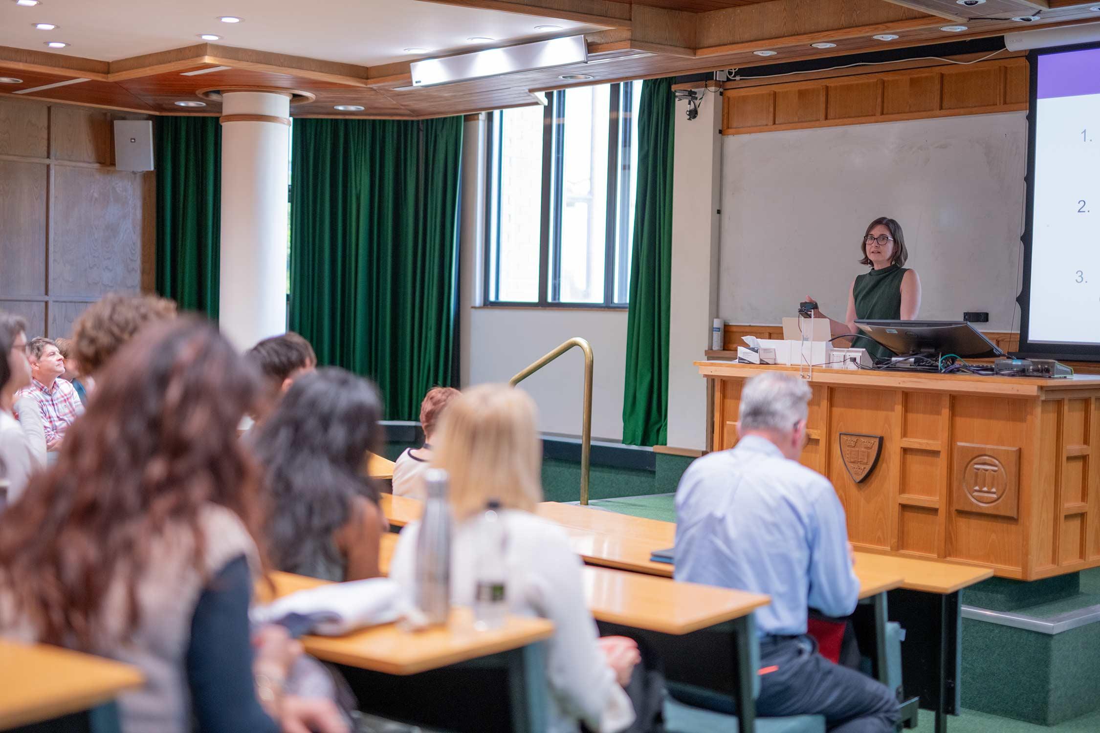 a scientist addresses an audience in a lecture theatre
