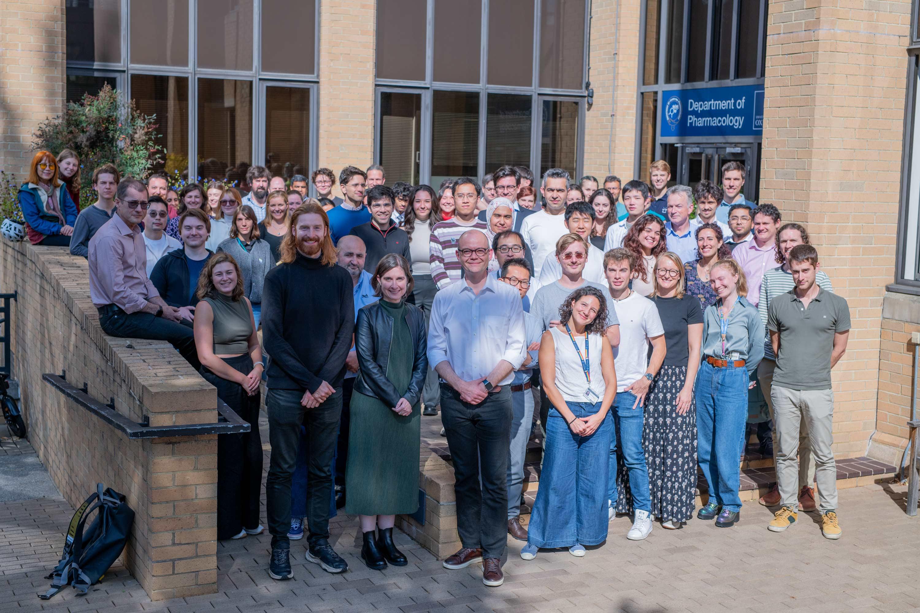 a group photo of people in front of a building