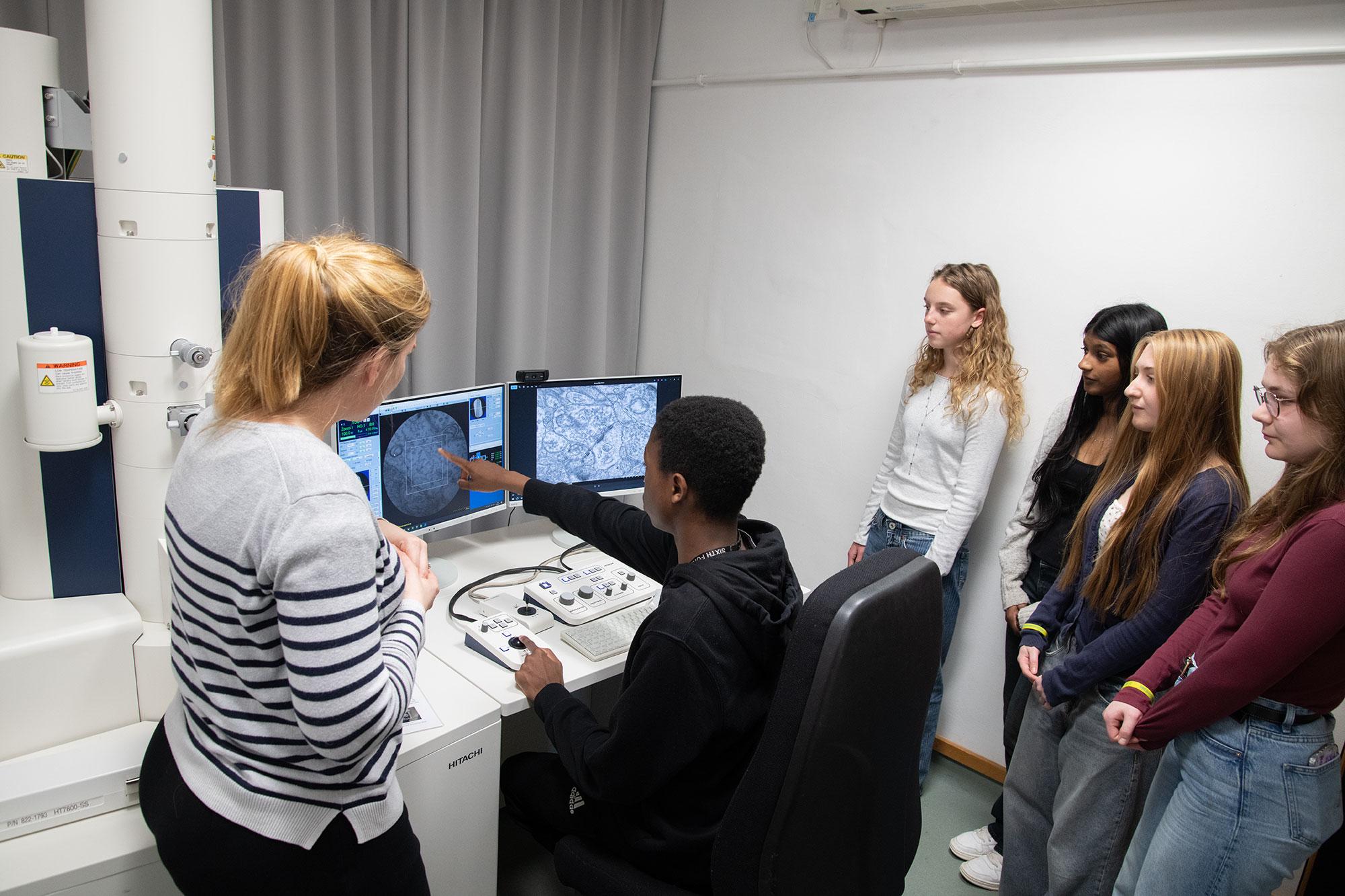 a research and students with a transmission electron microscope